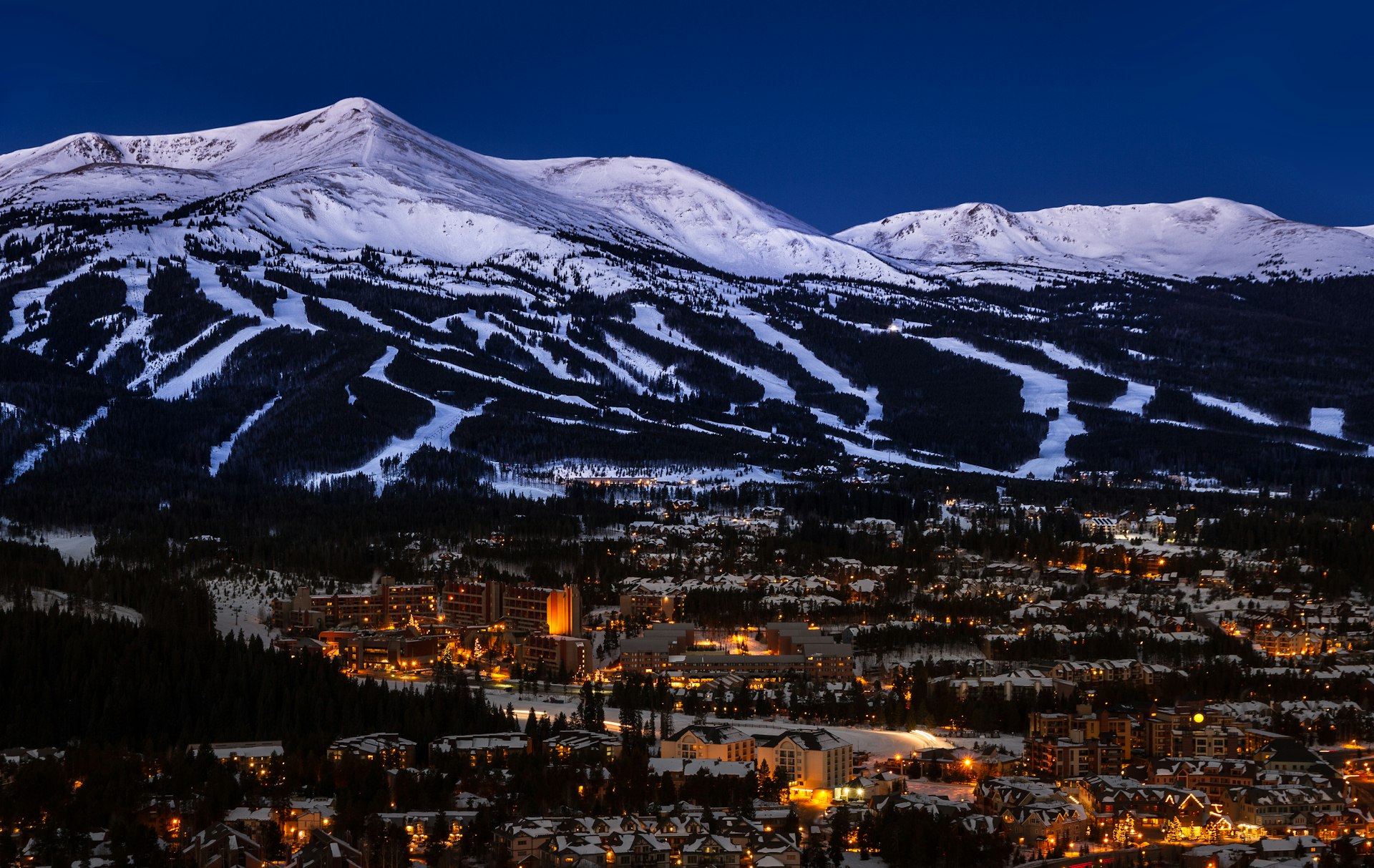 An aerial view of the slopes over the town of Breckenridge at night