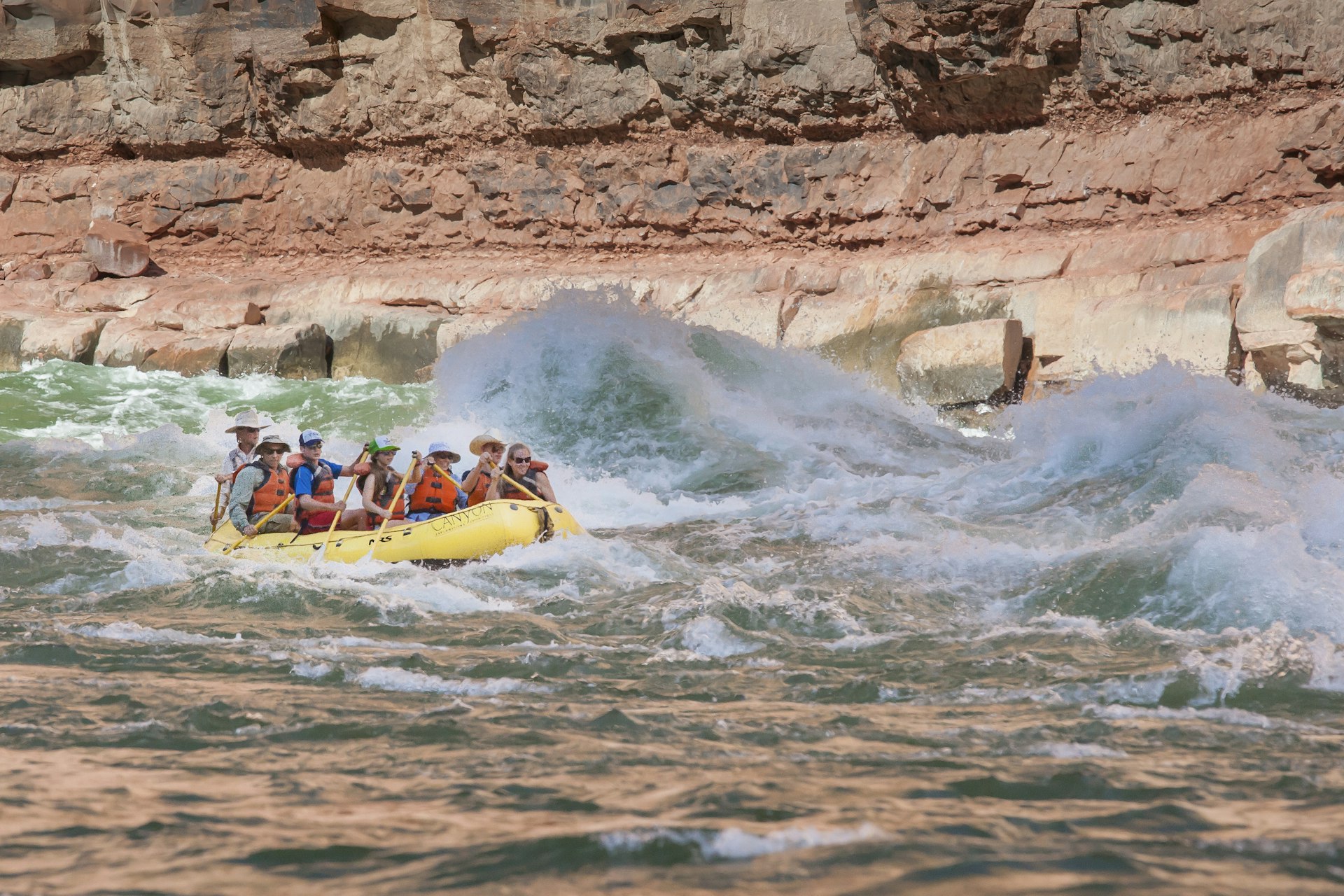 A group paddles a raft through rapids in Grand Canyon National Park, Arizona, USA