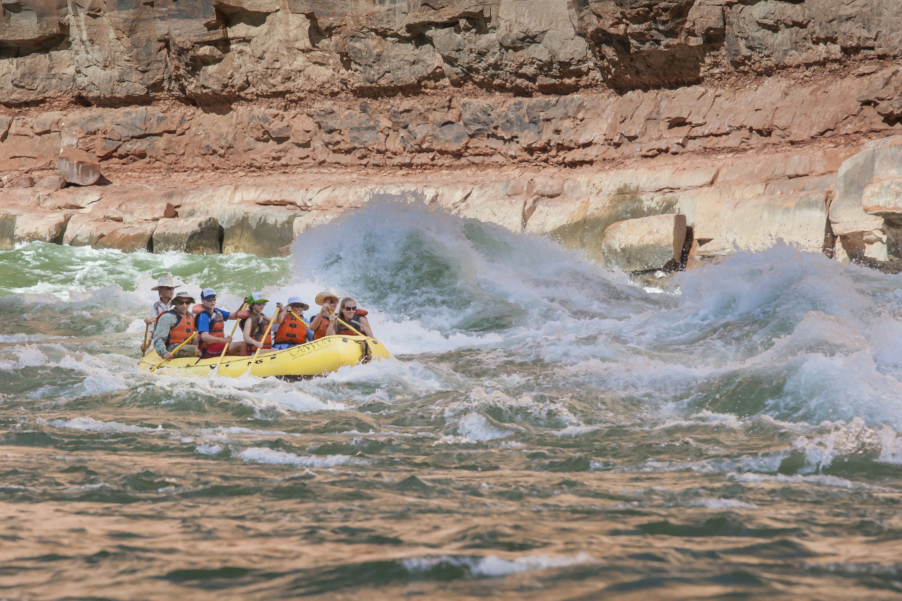 A group paddles a raft through rapids in Grand Canyon National Park, Arizona, USA