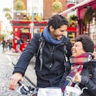 A young, mixed-race couple laughing together in Temple Bar, Dublin