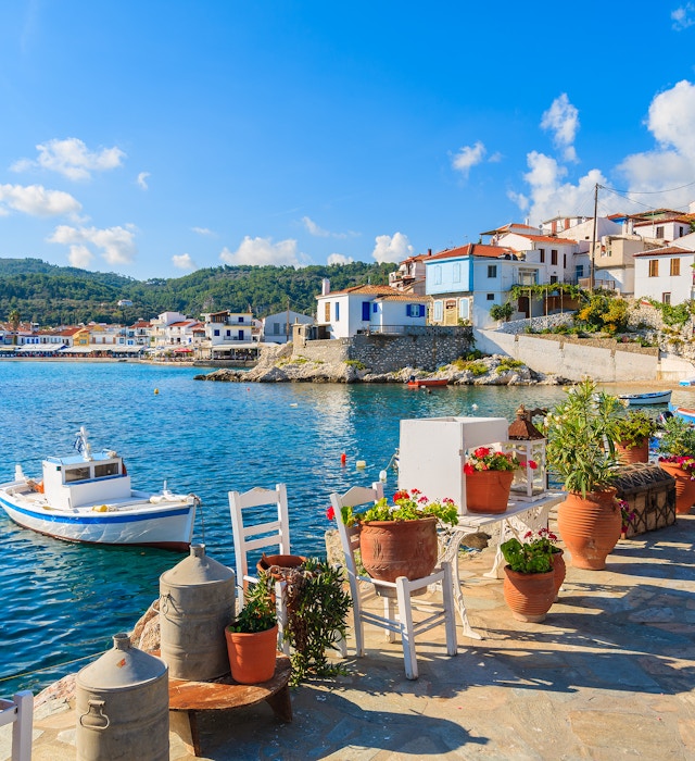 Flower pots on and view of fishing boats anchoring in Kokkari bay, Samos island, Greece - stock photo
Samos is a Greek island in the eastern Aegean Sea, south of Chios, north of Patmos.
© pkazmierczak / Getty