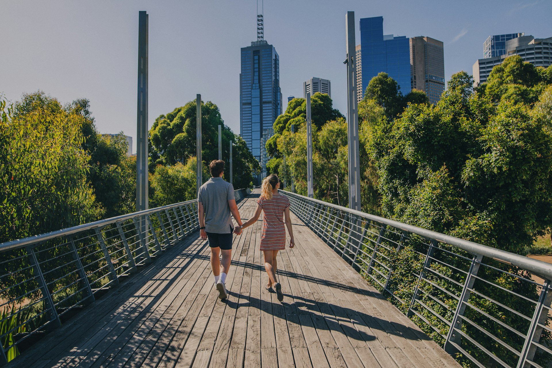 Young couple walking through Birrarung Marr in Melbourne, Australia