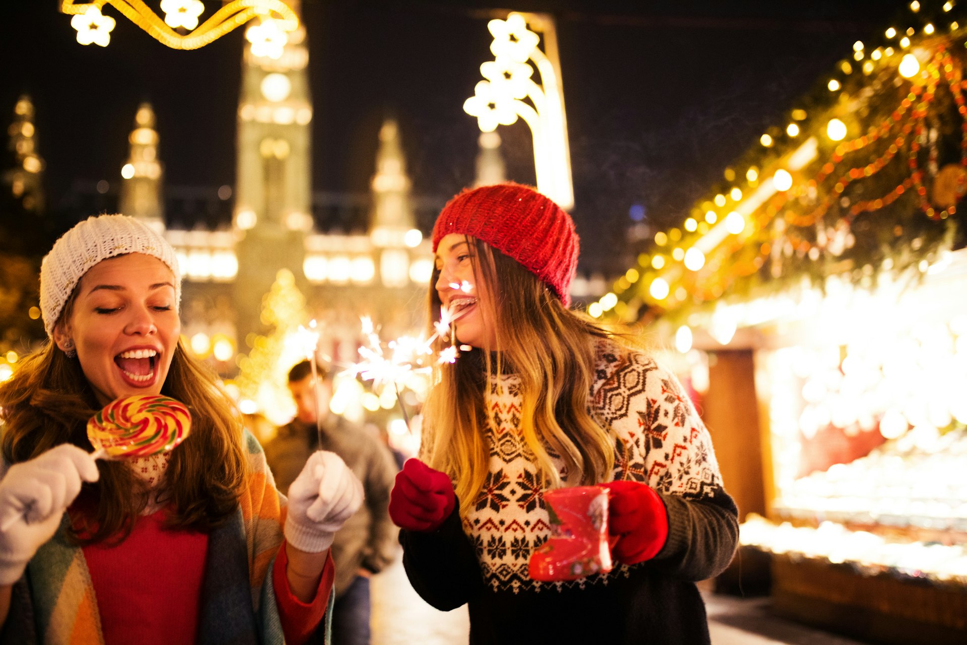 Girl friends having fun and enjoying a Christmas market in Vienna, in front of Schloss Schönbrunn