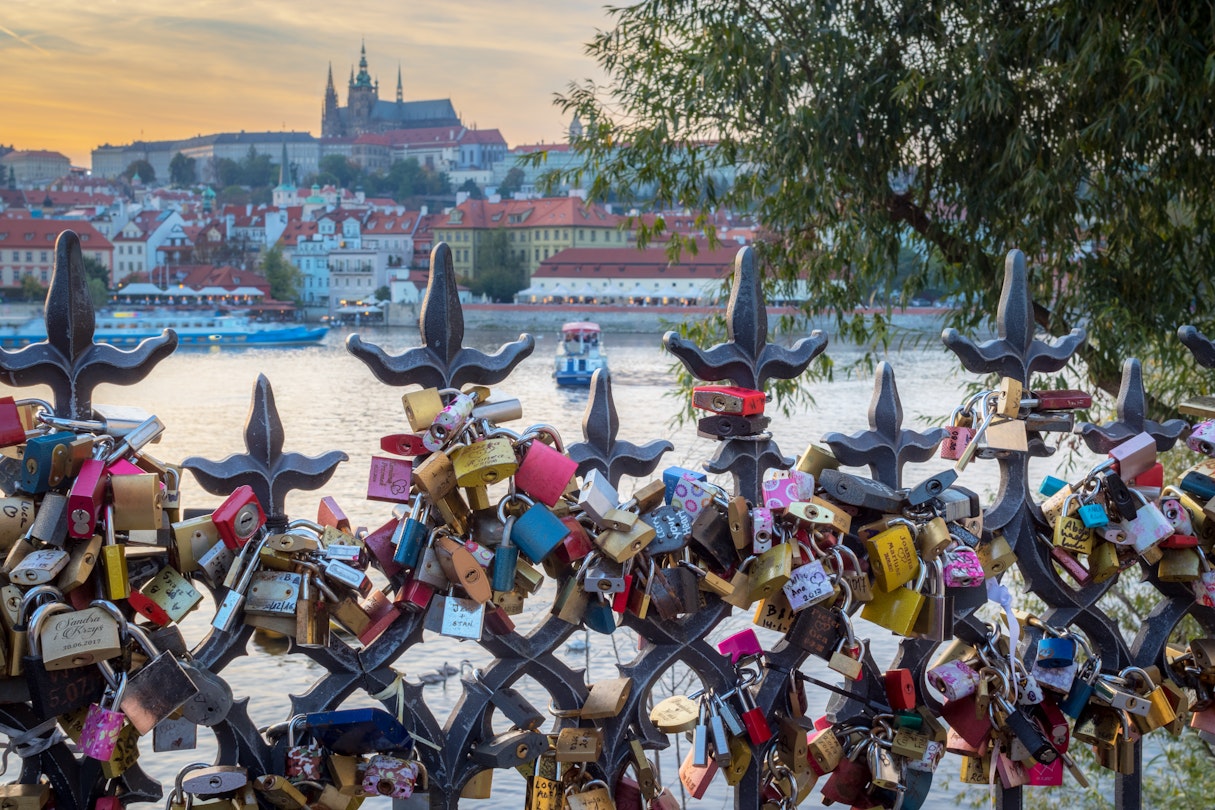 Lovers padlocks attached to a fence in the romantic citiy of Prague. Boats on Vltava river and Prague Castle in background
879952668