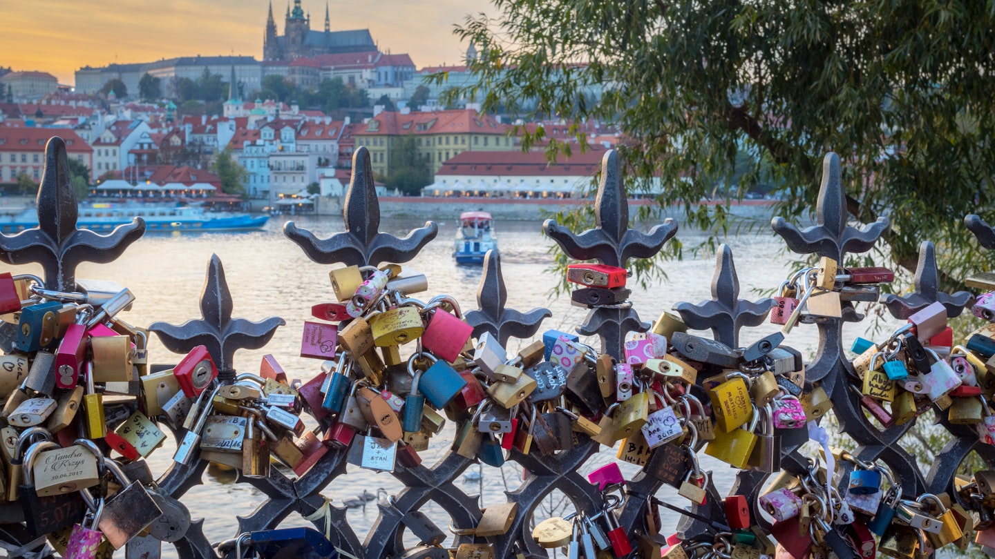 Lovers padlocks attached to a fence in the romantic citiy of Prague. Boats on Vltava river and Prague Castle in background
879952668