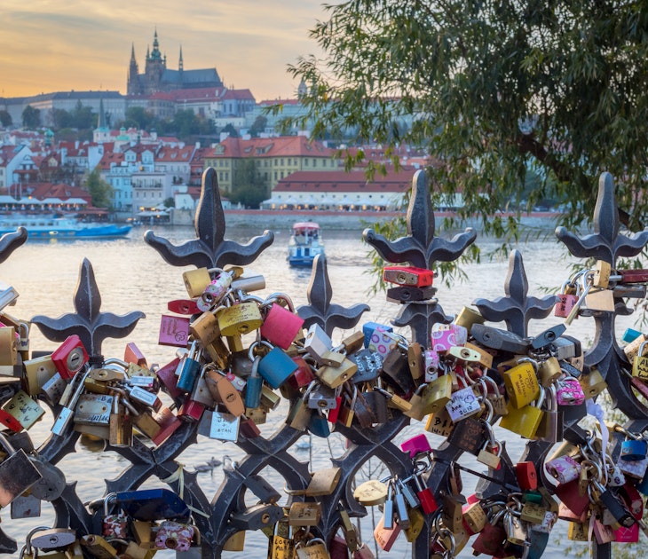 Lovers padlocks attached to a fence in the romantic citiy of Prague. Boats on Vltava river and Prague Castle in background
879952668