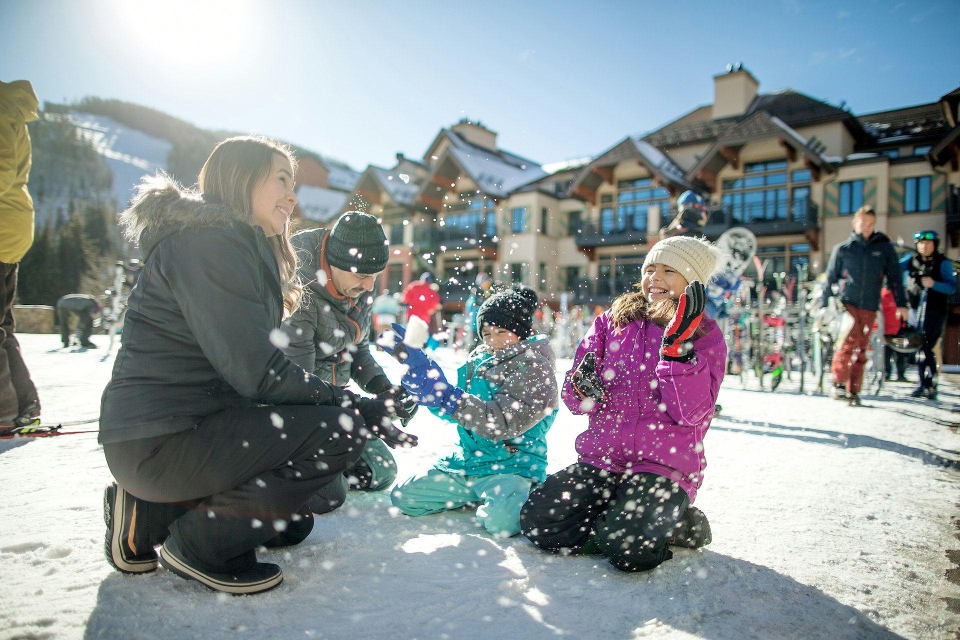 A family playing in the snow at a resort in Vail, Colorado, USA