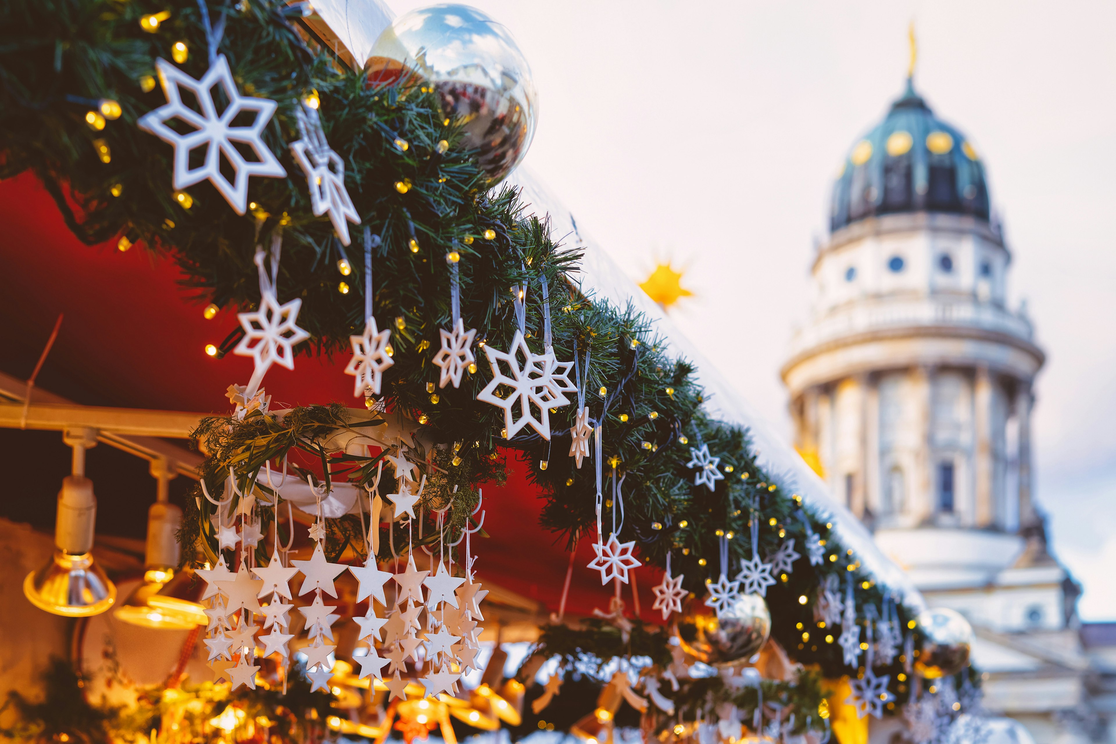 A Christmas market stall decorated with carved snowflakes.