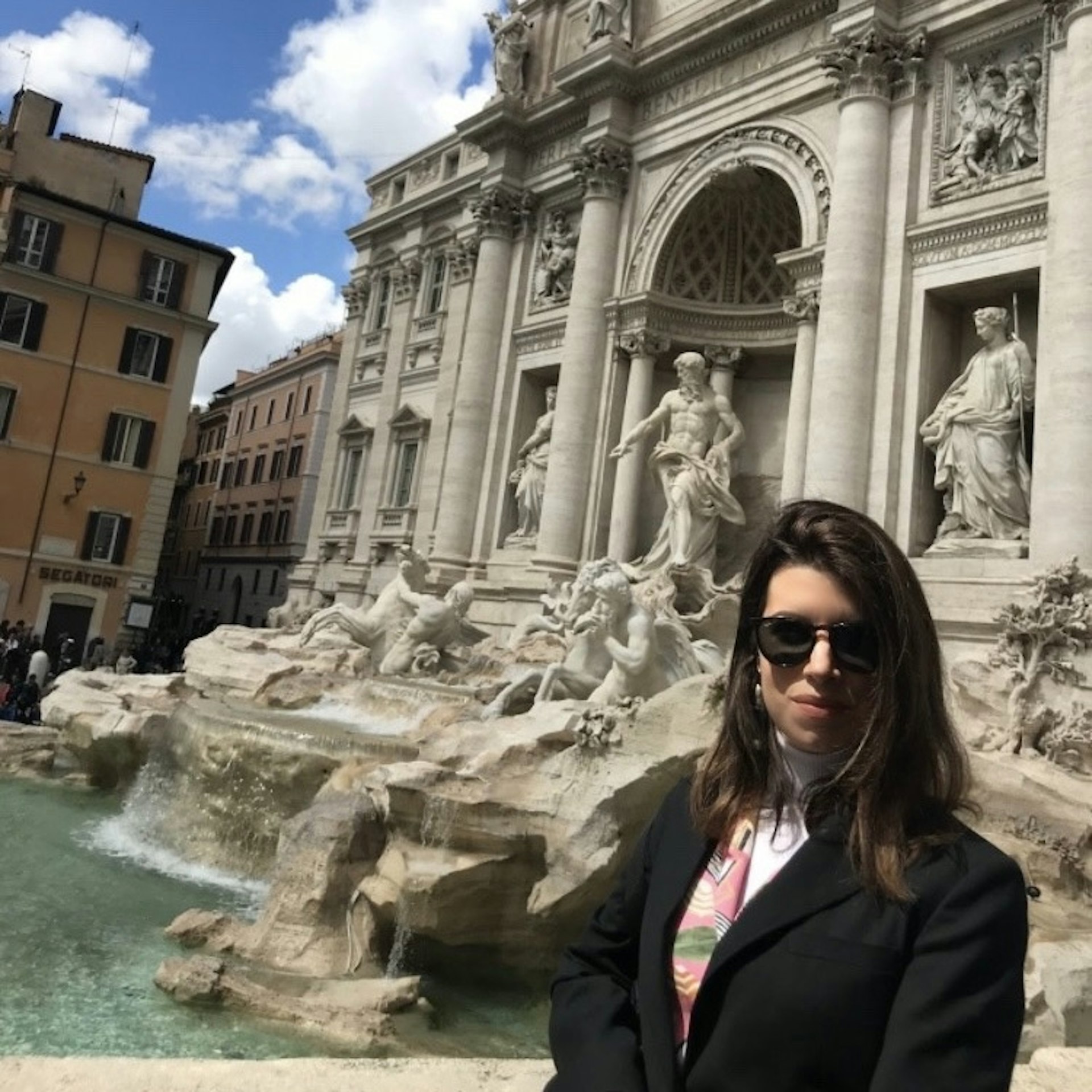 Sasha Brady standing in front of the Trevi Fountain in Rome, Italy