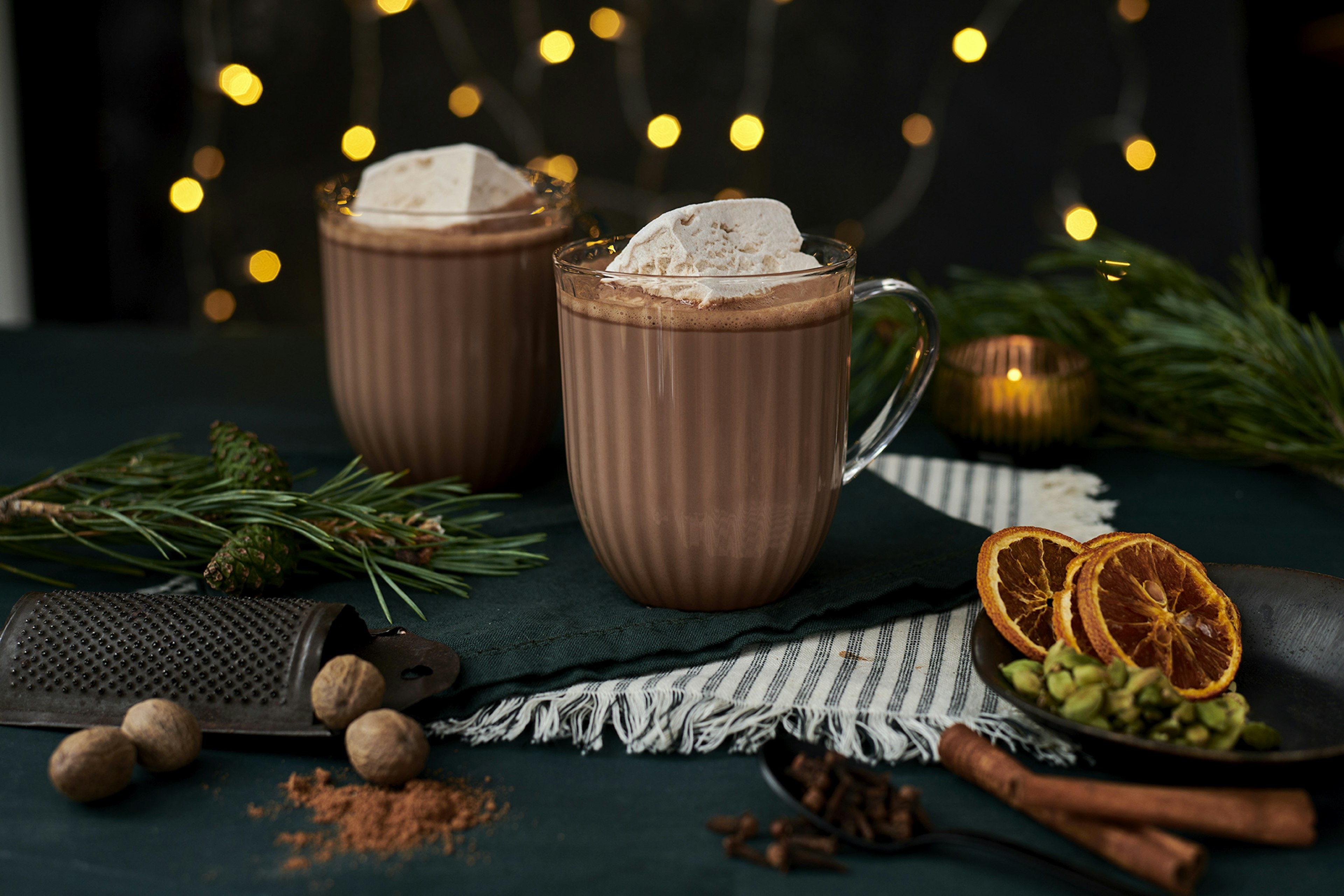 TWo mugs of Knoops luxury festive chocolate in a Christmas display