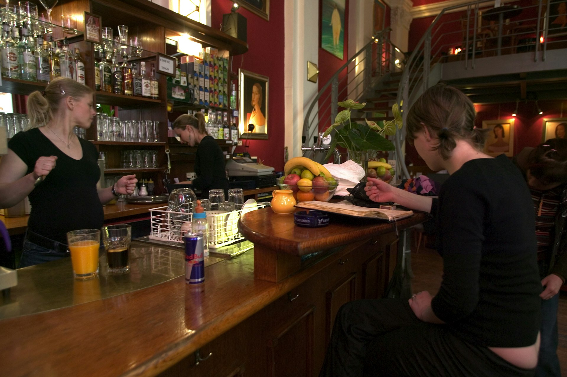 Bar tenders and customer at the bar, in the Cafe at the Globe Bookshop