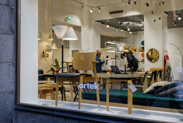 Customers seen through the Artek store window browsing - Helsinki, Finland