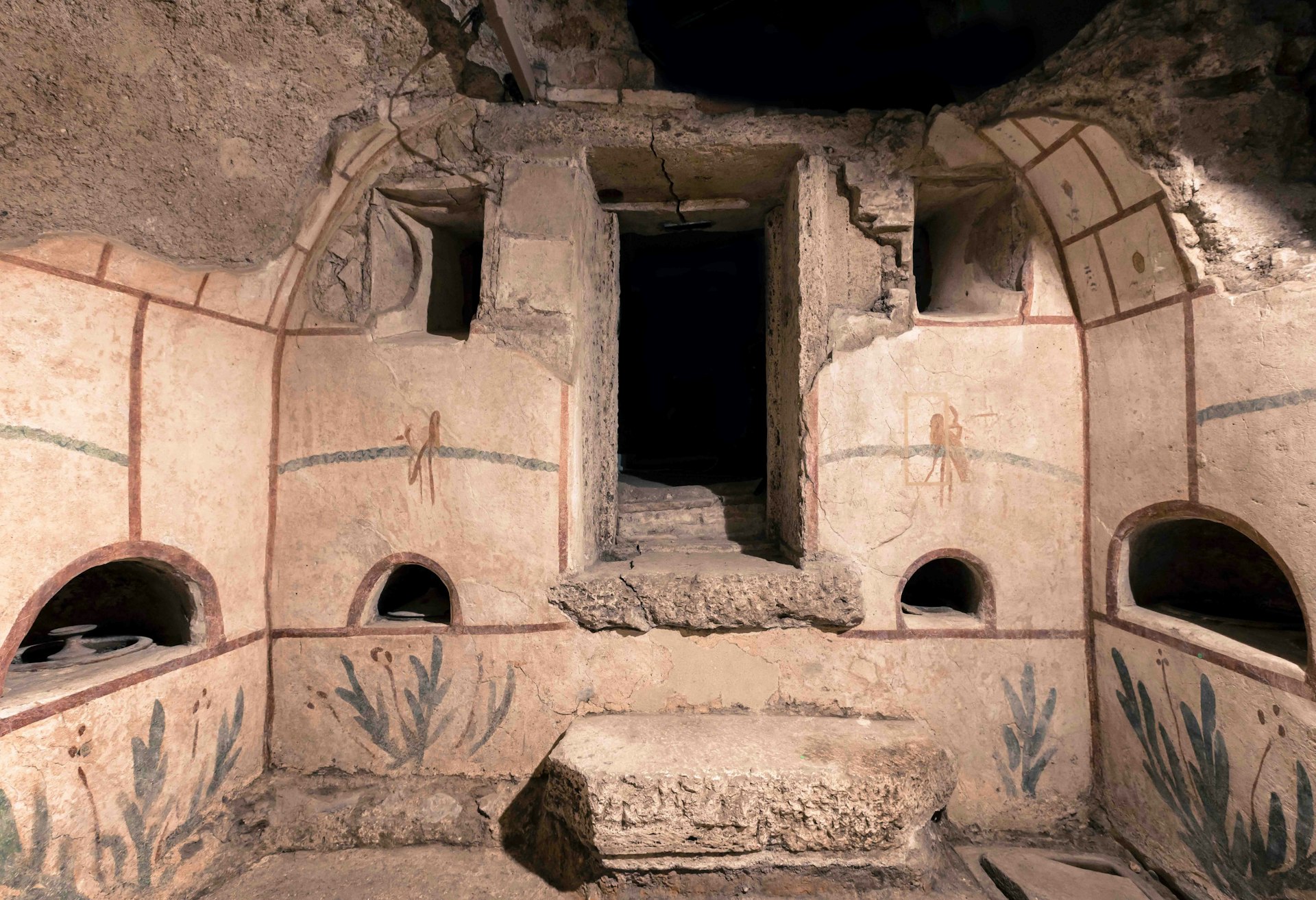 The entrance to an Ancient Roman burial tomb adorned with frescoes