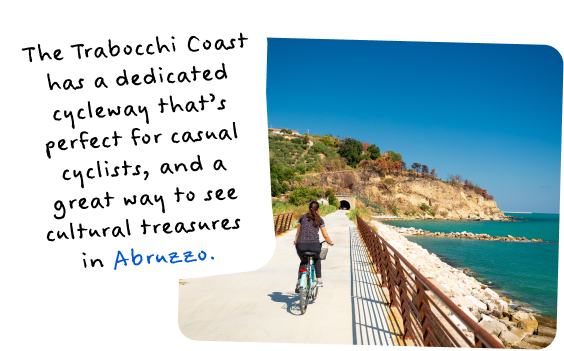 The Trabocchi Coast has a dedicated cycleway that's great for casual cyclists, and a great way to see Abruzzo. Image of a woman bike riding near the water.