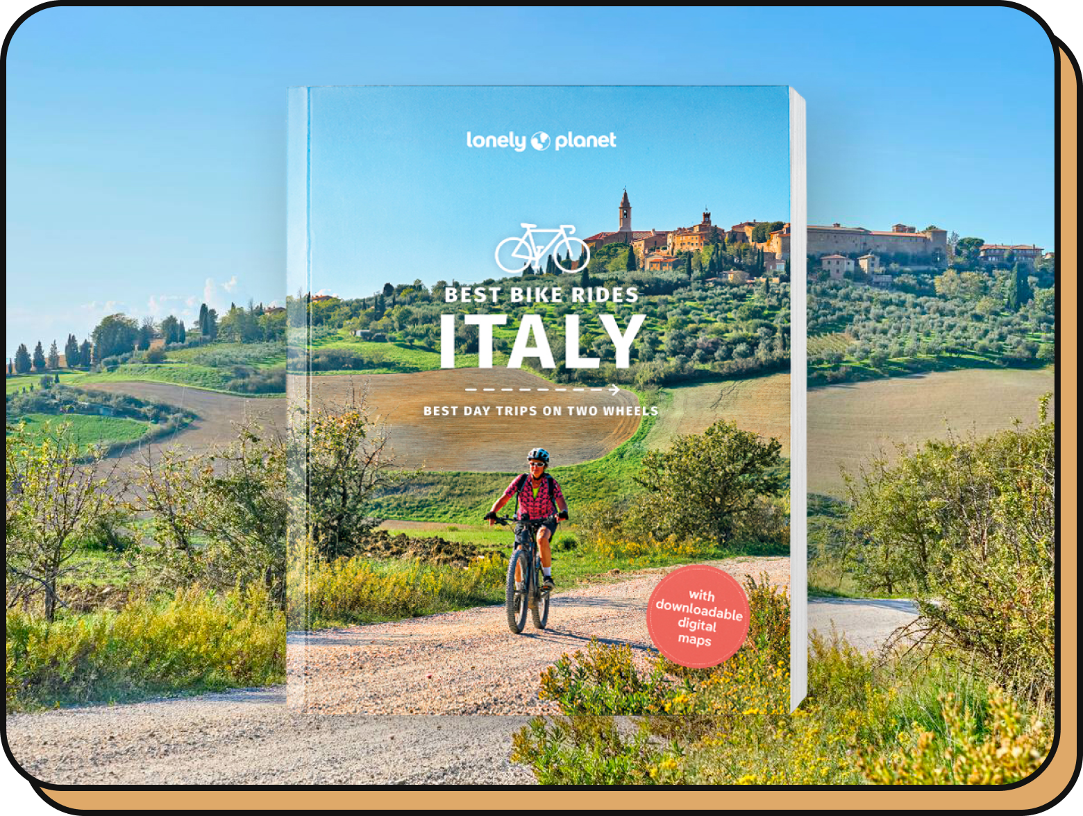 Best Bike Rides Italy book alongside a landscape.