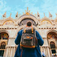 Man looking at a cathedral in Venice