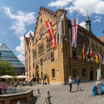 Ulm, BW / Germany - 14 July 2020: view of the town square in historic Ulm with people enjoying a day out
1256720641
architectural detail, baden-wuerttemberg, bar, buildings, city center, contrast, downtown, eat, european, german, have a drink relax, historic, homes, landmark, lifestyle, many, meet friends, narrow street, people bicycle, rathaus, rathausplatz, shops, sightseeing, socialize