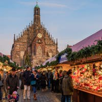 Glowing Christmas market stall at dusk in Nuremberg