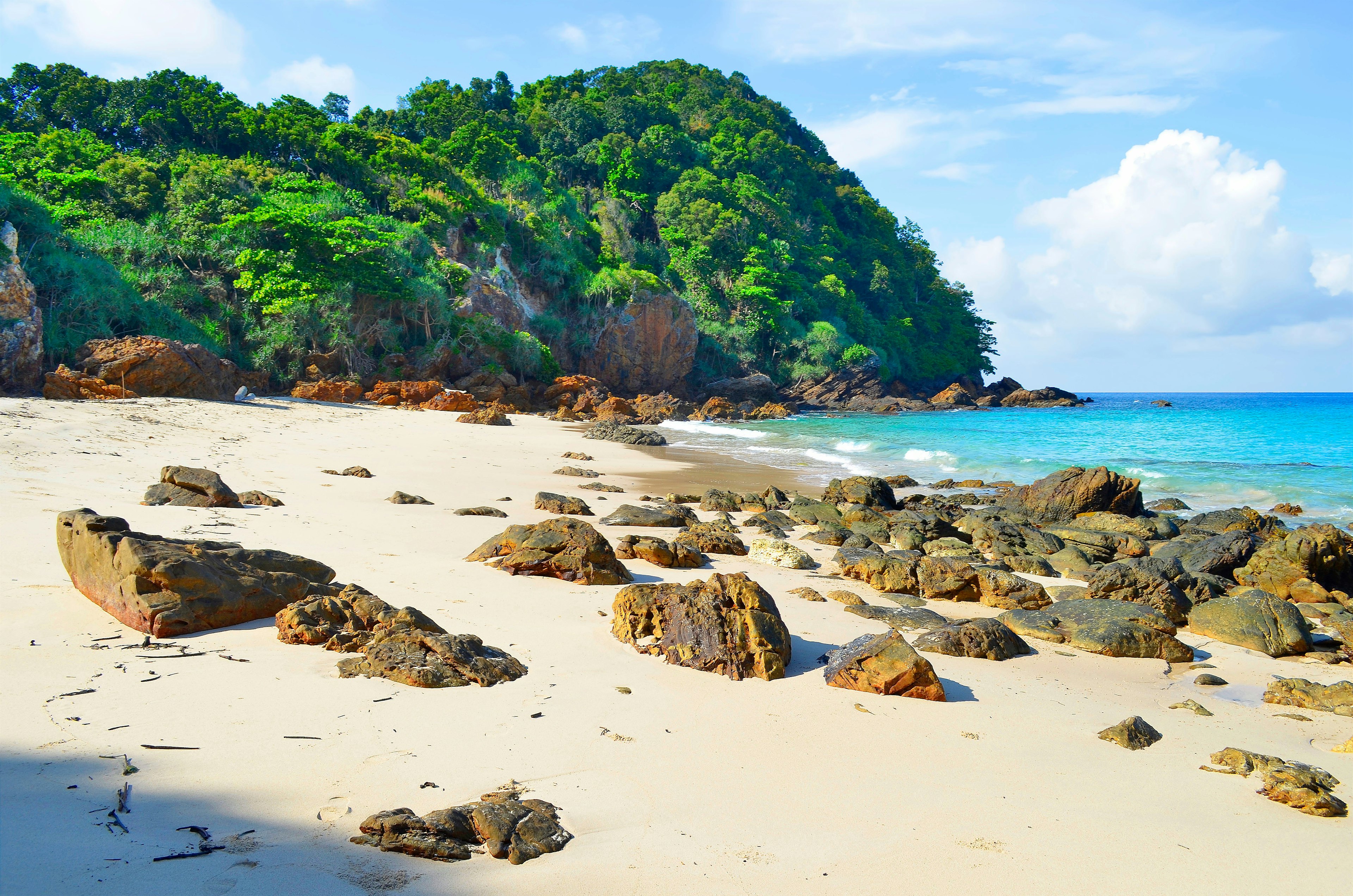 An empty beach with rocky boulders