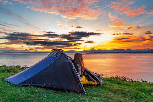 Woman watching the morning sunrise over water from her tent while wild camping in the Isle of Skye, Scotland, UK
1822498943
tent, forest, sunrise, cliff, isle of skye, young, expedition, tourism, clouds, holiday, sun, summer, scotland, beautiful, mountain, trip, grass, uk, vacation, isle of skye scotland, leisure, park, sky, camping tent, green, nature, countryside, relaxation, active, equipment, hiking, wild camping, people, water, camp, morning, adventure, outdoor, blue, ocean, light, backpack, sunset, backpacking, travel, lake, landscape