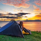Woman watching the morning sunrise over water from her tent while wild camping in the Isle of Skye, Scotland, UK
1822498943
tent, forest, sunrise, cliff, isle of skye, young, expedition, tourism, clouds, holiday, sun, summer, scotland, beautiful, mountain, trip, grass, uk, vacation, isle of skye scotland, leisure, park, sky, camping tent, green, nature, countryside, relaxation, active, equipment, hiking, wild camping, people, water, camp, morning, adventure, outdoor, blue, ocean, light, backpack, sunset, backpacking, travel, lake, landscape