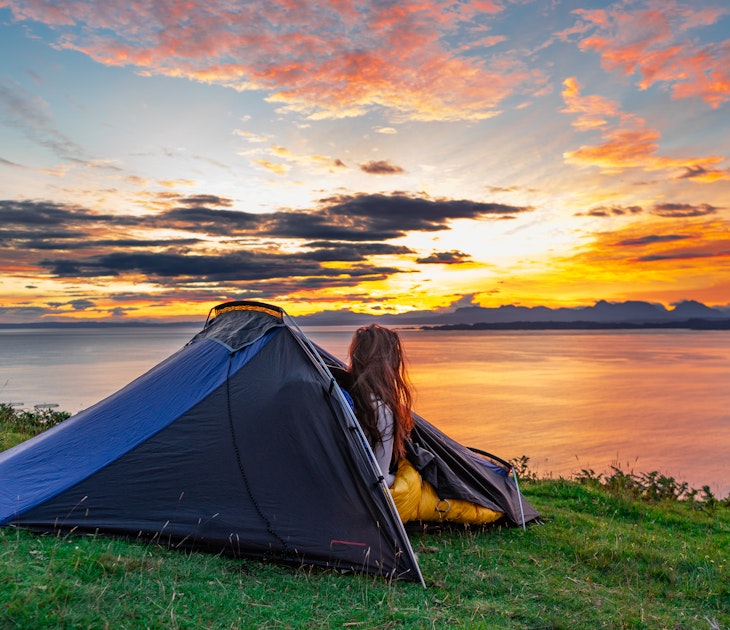 Woman watching the morning sunrise over water from her tent while wild camping in the Isle of Skye, Scotland, UK
1822498943
tent, forest, sunrise, cliff, isle of skye, young, expedition, tourism, clouds, holiday, sun, summer, scotland, beautiful, mountain, trip, grass, uk, vacation, isle of skye scotland, leisure, park, sky, camping tent, green, nature, countryside, relaxation, active, equipment, hiking, wild camping, people, water, camp, morning, adventure, outdoor, blue, ocean, light, backpack, sunset, backpacking, travel, lake, landscape