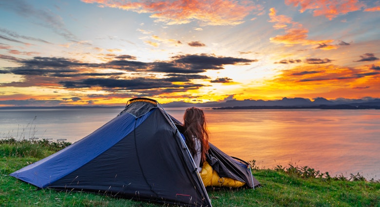 Woman watching the morning sunrise over water from her tent while wild camping in the Isle of Skye, Scotland, UK
1822498943
tent, forest, sunrise, cliff, isle of skye, young, expedition, tourism, clouds, holiday, sun, summer, scotland, beautiful, mountain, trip, grass, uk, vacation, isle of skye scotland, leisure, park, sky, camping tent, green, nature, countryside, relaxation, active, equipment, hiking, wild camping, people, water, camp, morning, adventure, outdoor, blue, ocean, light, backpack, sunset, backpacking, travel, lake, landscape