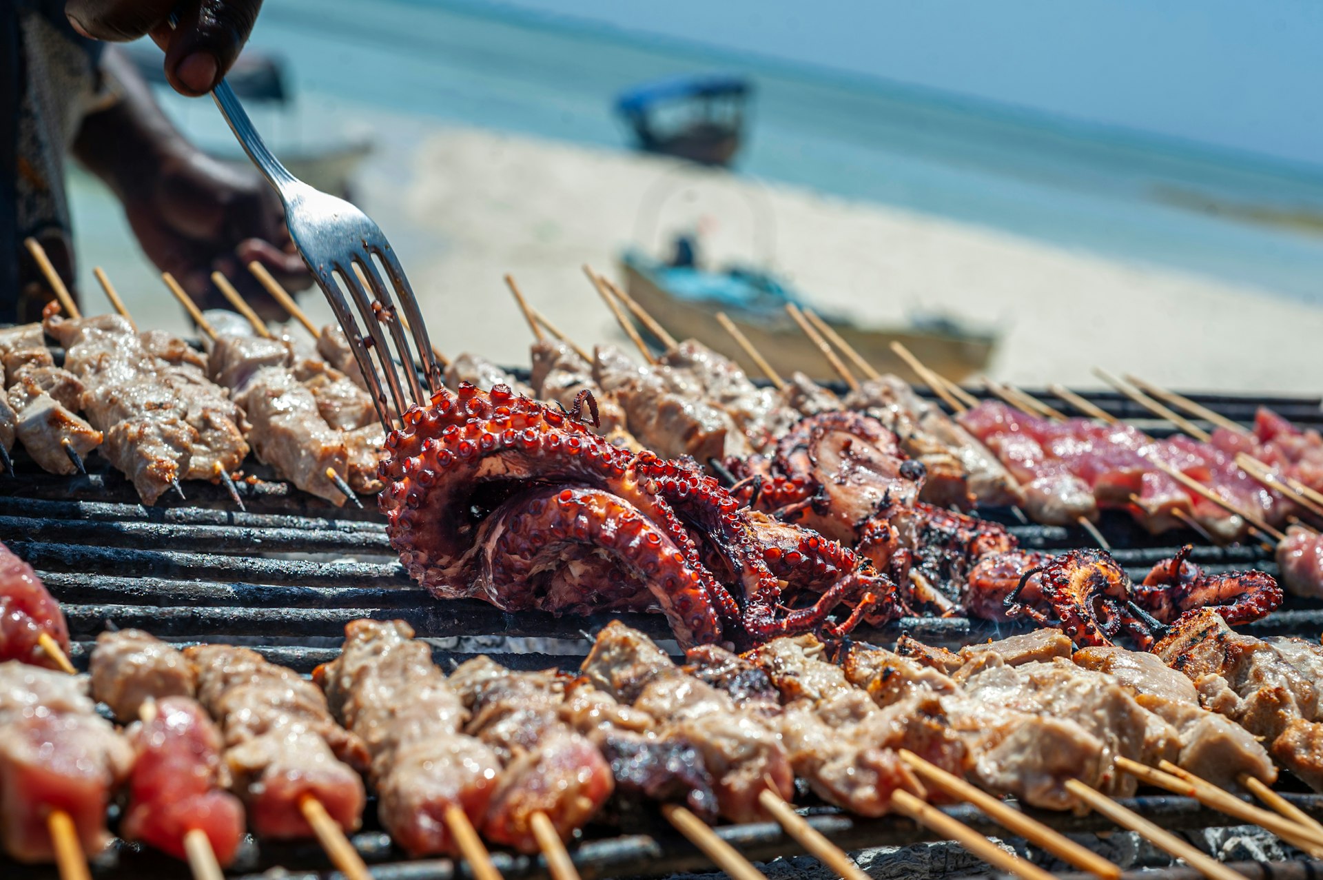 Close-up of seafood being served at a beach barbecue 