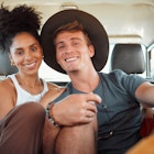 A man and woman smiling in the back of a truck on a safari in Kenya