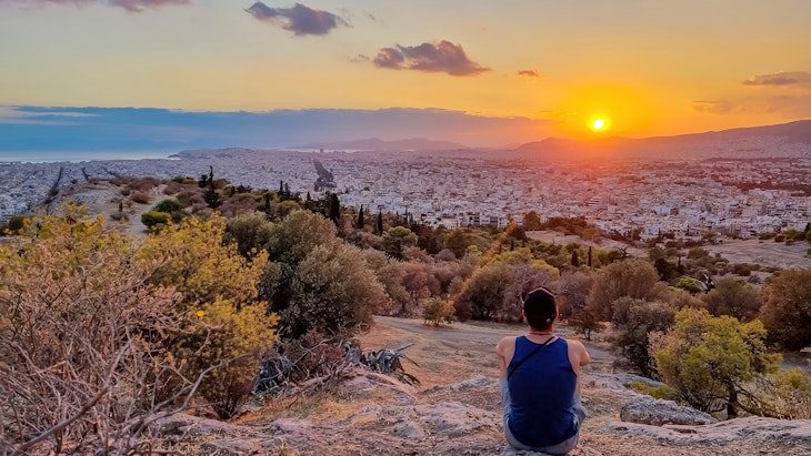 Tourist man watching the sunset over city of Athens seen from Filopappou Hill (hill of muses), Athens, Attica, Greece, Europe. Athens cityscape and Aegean sea. Beautiful sunset point with aerial view; Shutterstock ID 2322198929; full: 65050; gl: Online editorial; netsuite: Athens things to do; your: Claire Naylor
2322198929