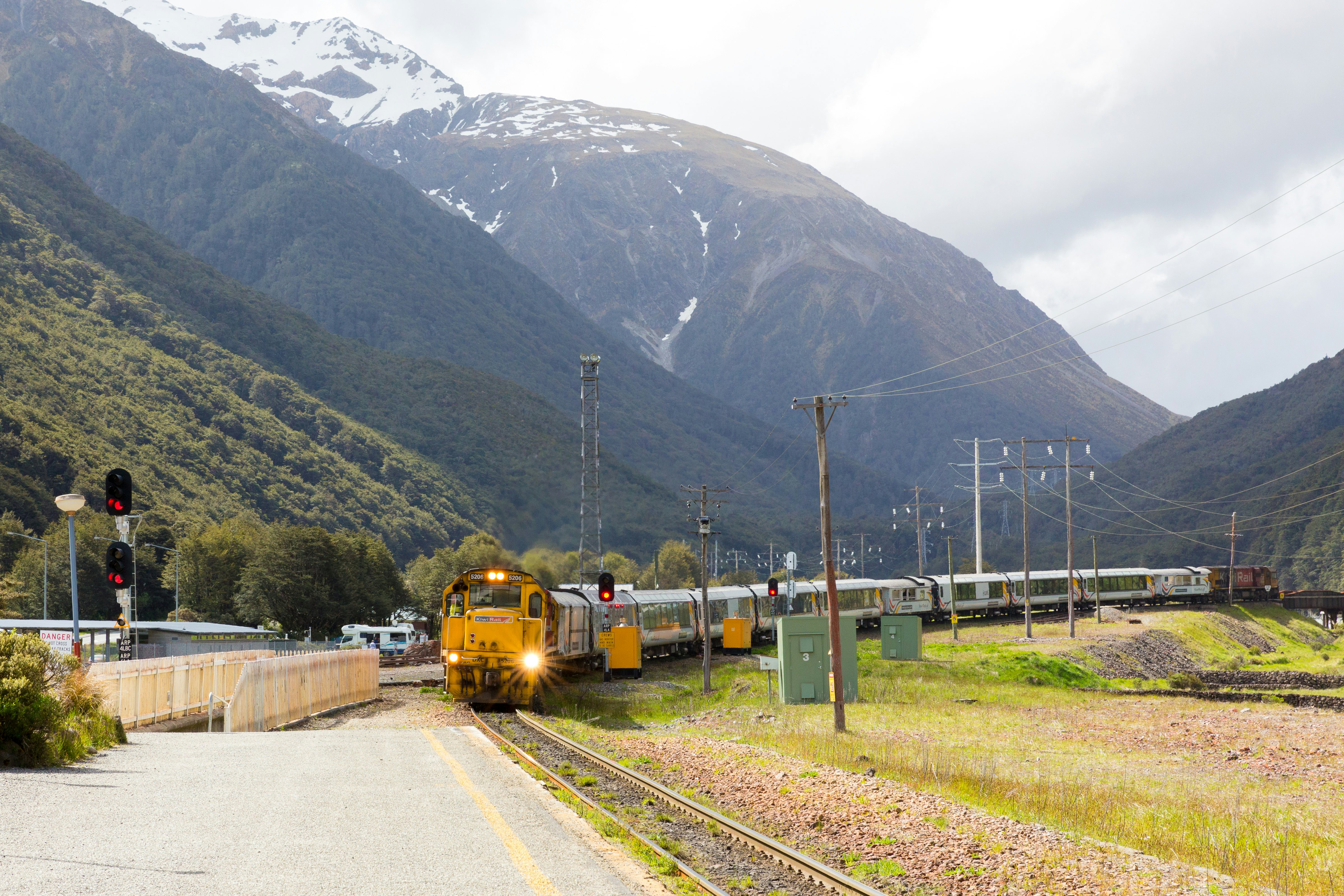 A Kiwirail TranzAlpine train arriving in Arthur’s Pass station, Arthur’s Pass National Park, South Island, New Zealand