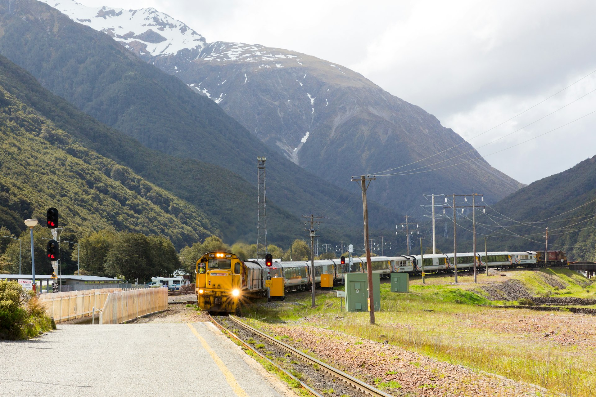 A Kiwirail TranzAlpine train arriving in Arthur’s Pass station, Arthur’s Pass National Park, South Island, New Zealand