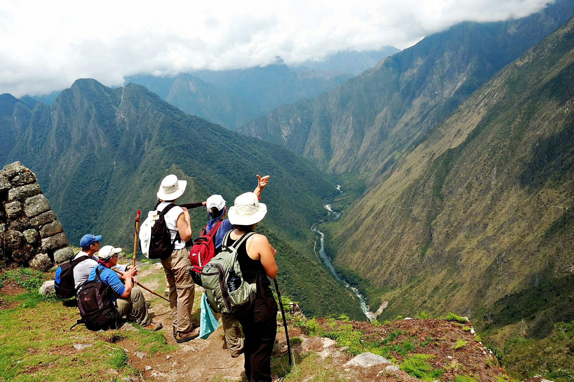 A group of hikers look out over a valley along the Inca Trail in Peru