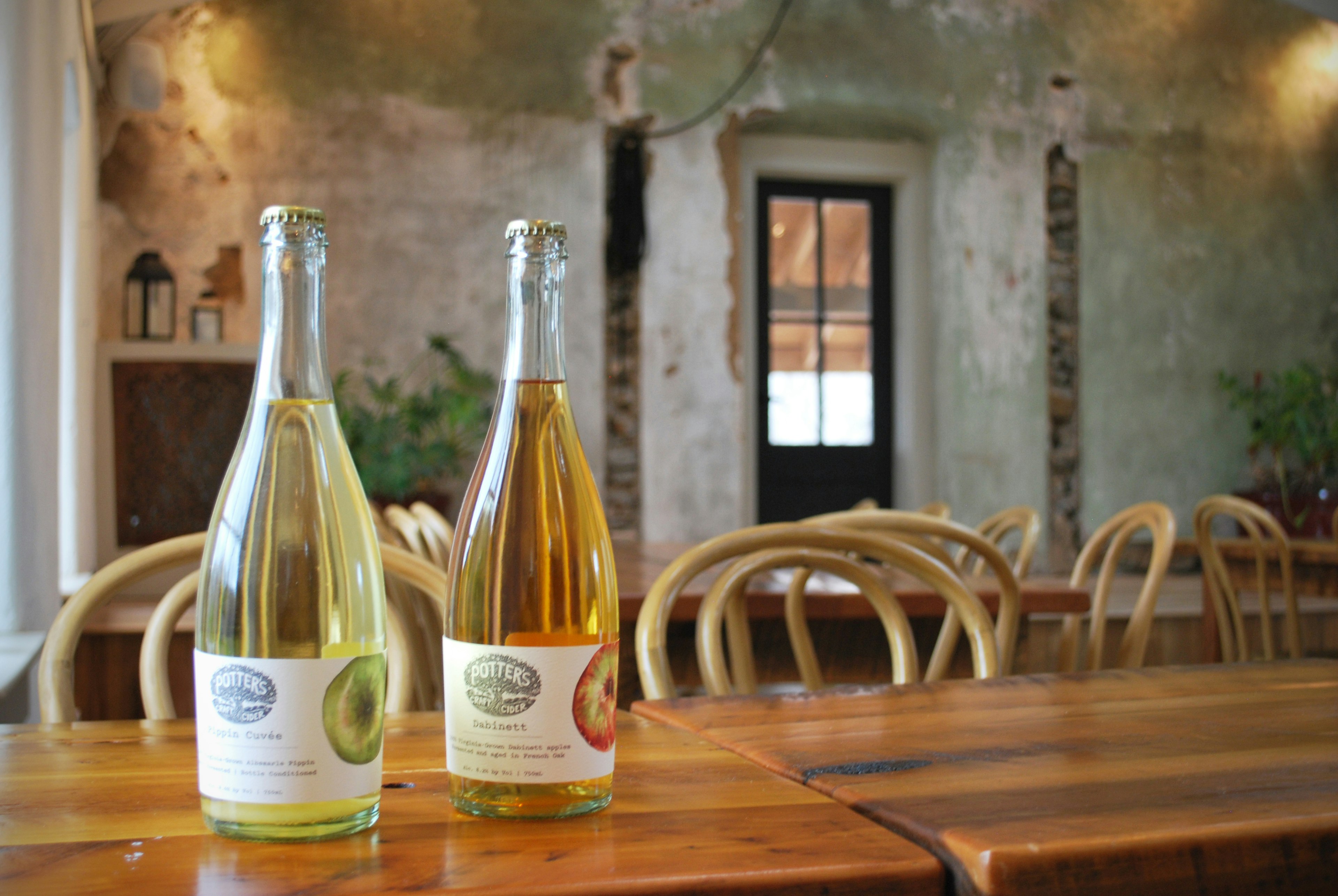 Two bottles of Potter's Craft Cider on a table