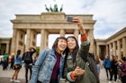 Female friends taking selfie against Brandenburg Gate - stock photo
Cheerful female friends taking selfie against Brandenburg Gate during vacation