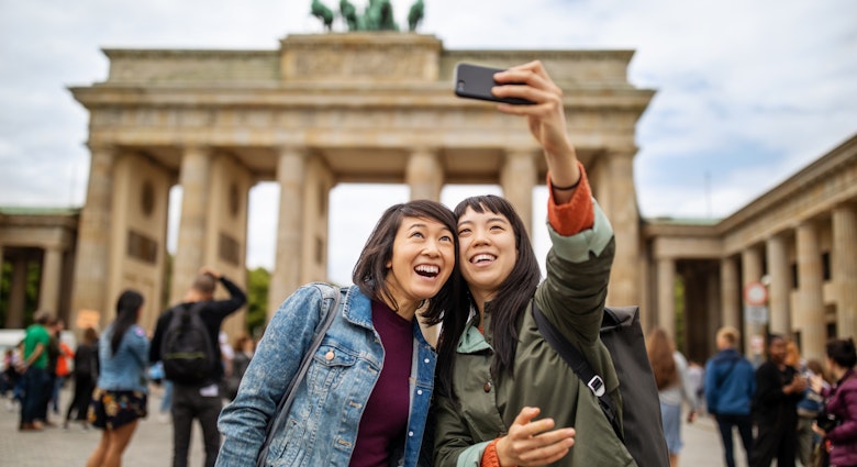 Female friends taking selfie against Brandenburg Gate - stock photo
Cheerful female friends taking selfie against Brandenburg Gate during vacation