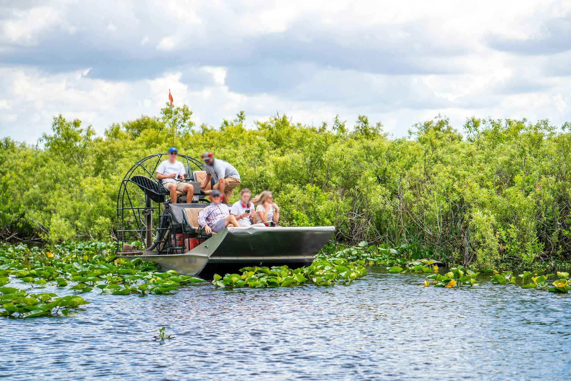 A group of tourists in a hovercraft in the wetlands of Everglades National Park, Florida, USA
