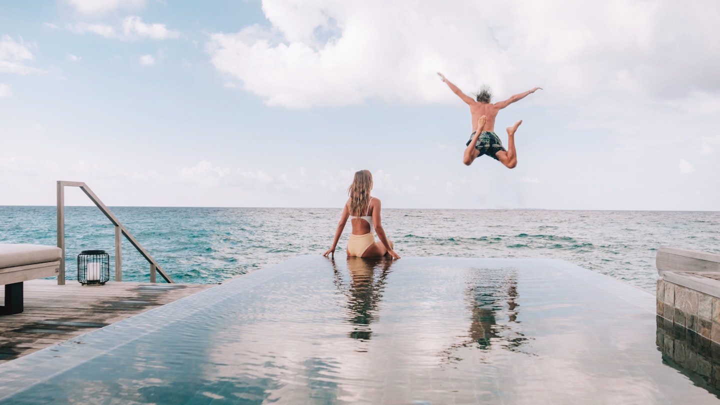 Couple enjoying luxury vacations - stock photo
Couple enjoying tropical vacations from the edge of an infinity pool in private over water villa. People travel luxury holidays