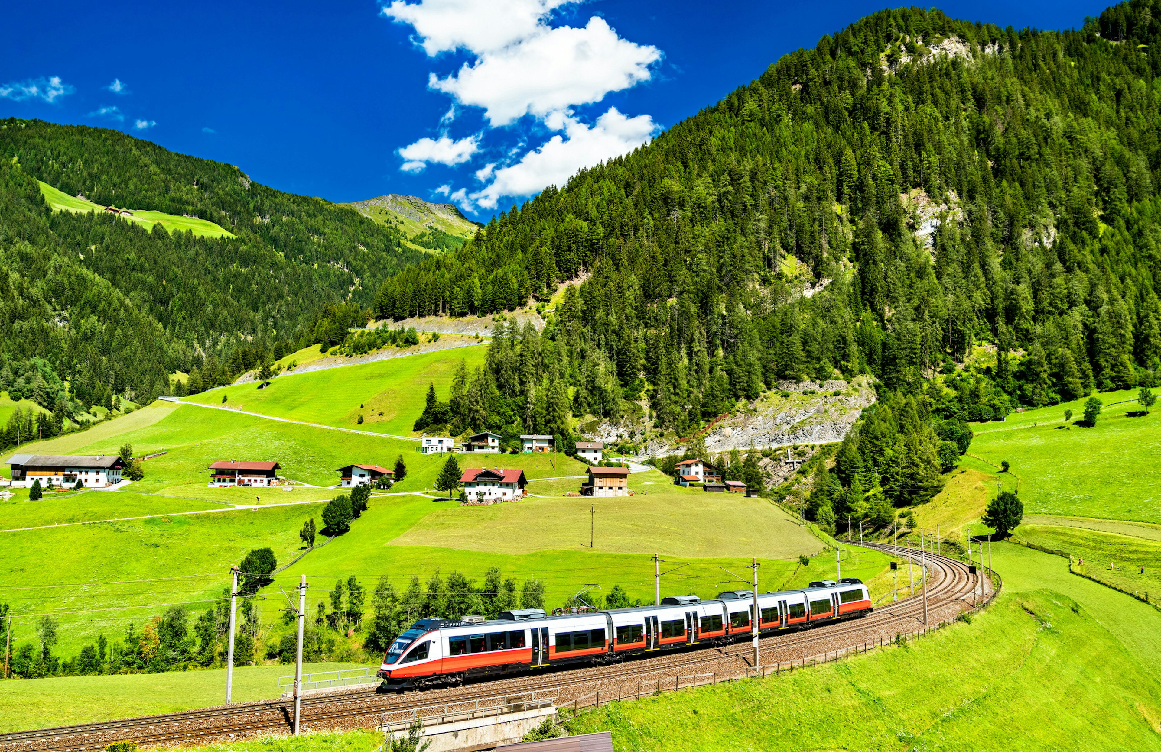 A regional train on the Brenner Railway cuts through in the Austrian Alps