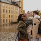 A woman and man laughing together next to a canal in Sweden