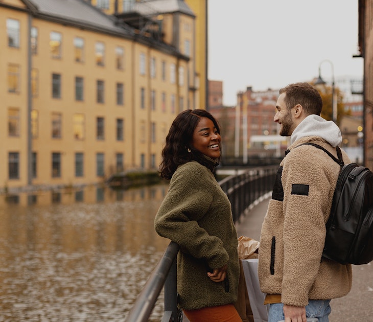 A woman and man laughing together next to a canal in Sweden