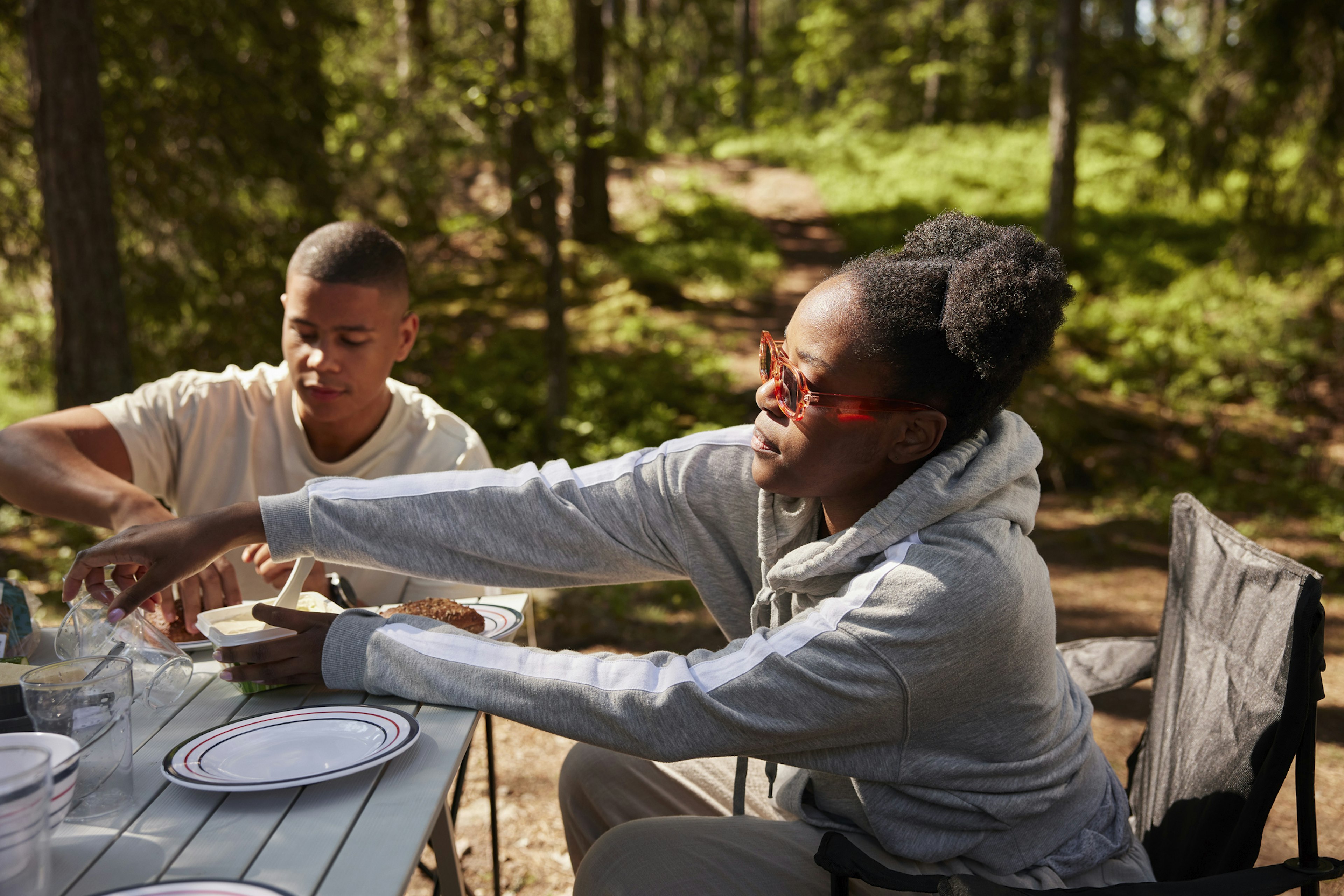 Two friends eating at a campsite in Sweden