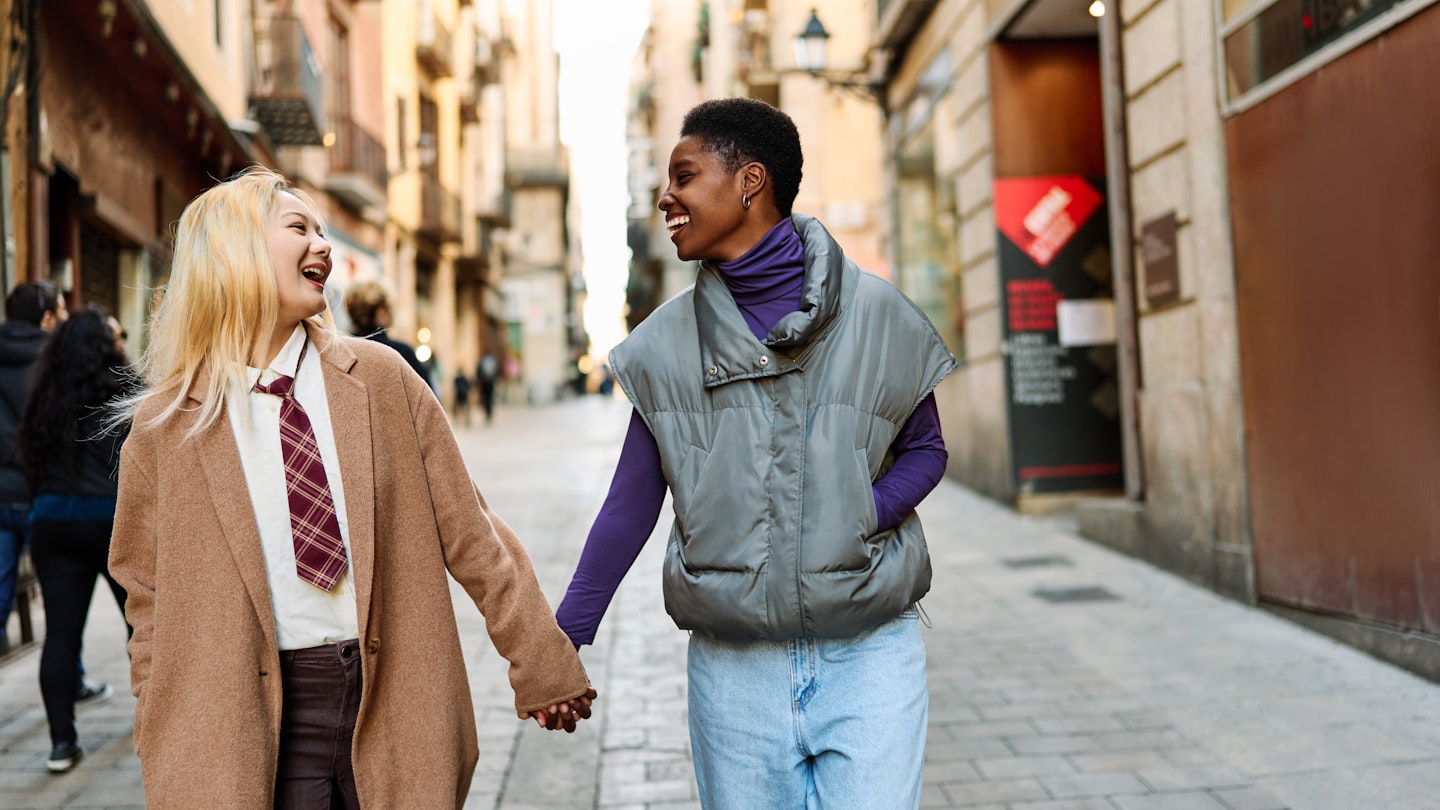 Happy mutiethnic lesbian tourist couple walking along a street in Barcelona city
1457851407
