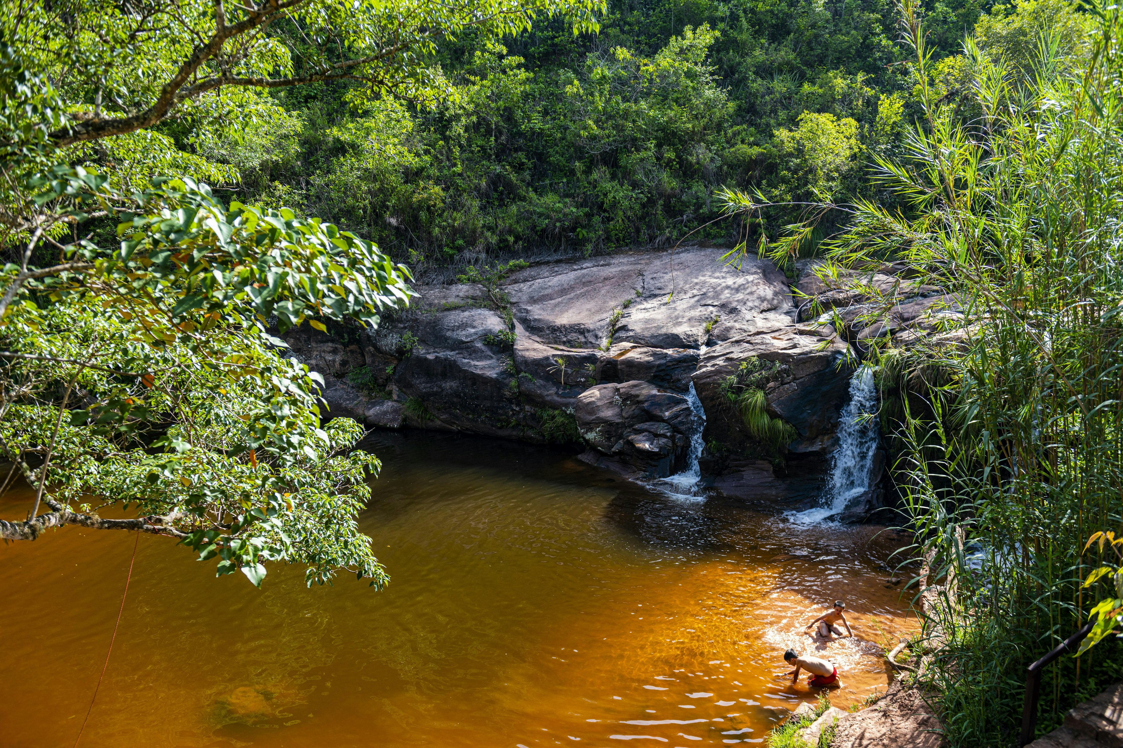 Two young boys playing in the water at Las Cuevas waterfalls near Samaipata, Bolivia