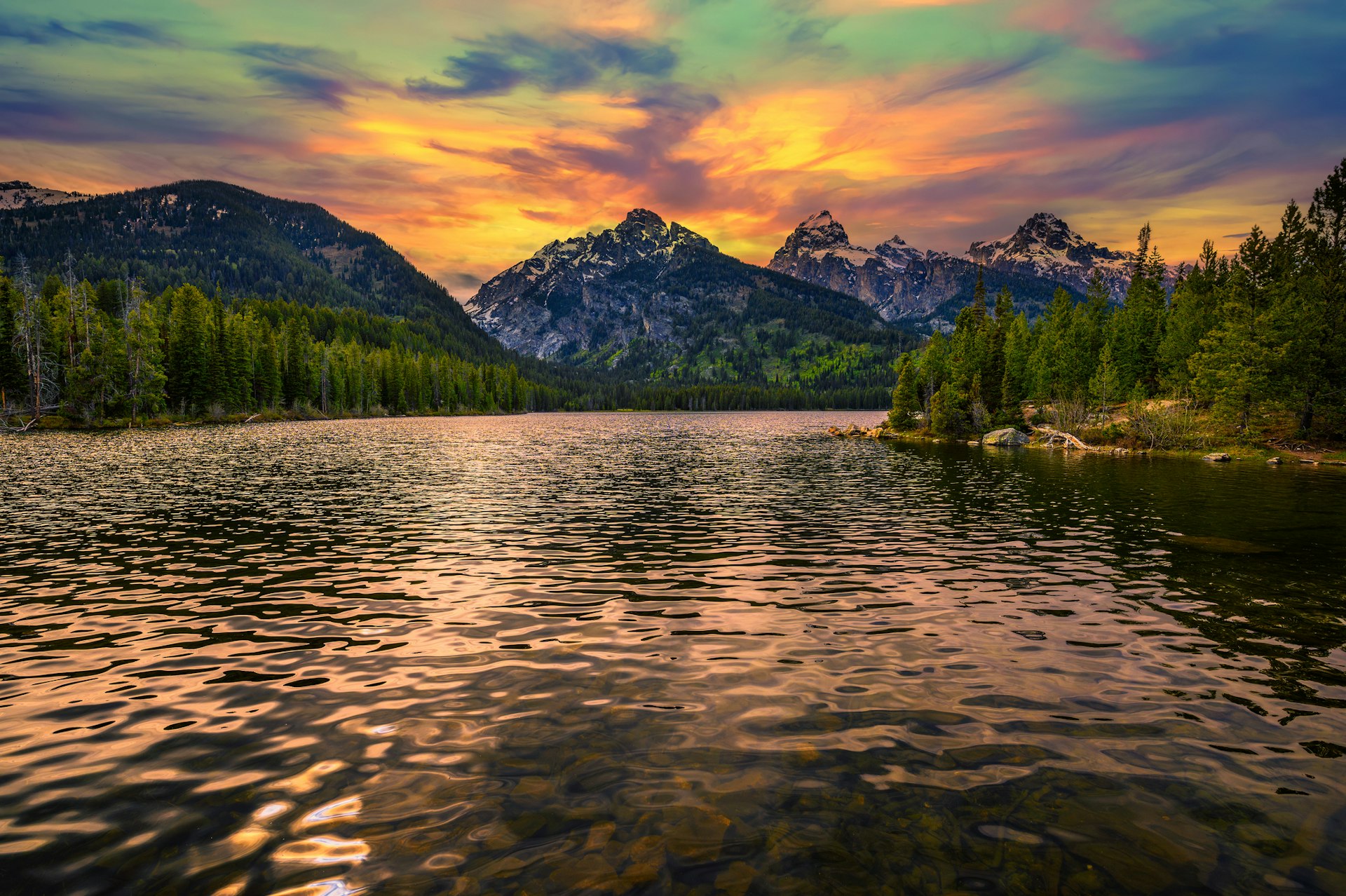 Sunset over Taggart Lake and Grand Teton Mountains in Wyoming, USA. Taggart Lake is a stunning alpine lake in Grand Teton National Park, surrounded by majestic mountains