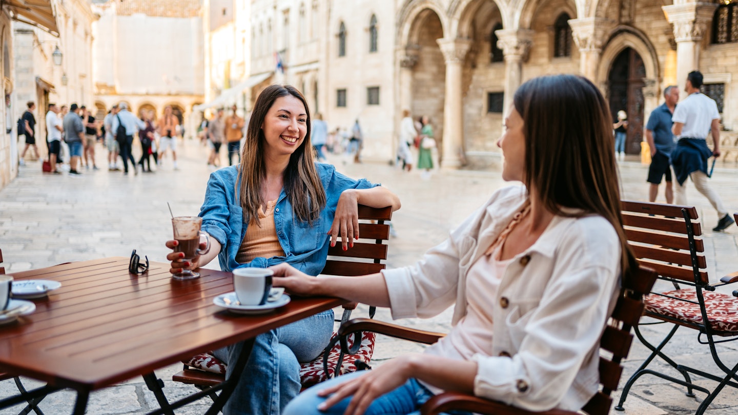 Two young female friends drinking coffee in a sidewalk cafÃ© in Dubrovnik, Croatia.
Two young female friends drinking coffee in a sidewalk café in Dubrovnik, Croatia.
1550680815