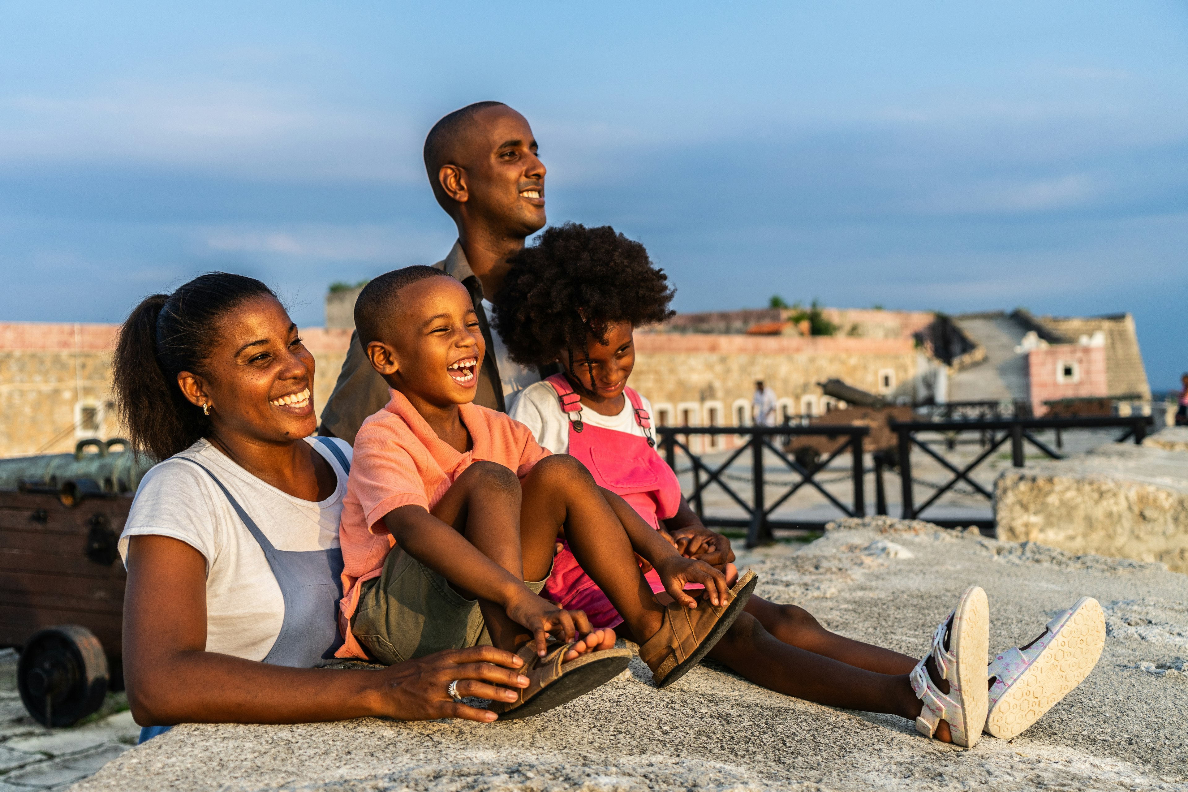 Family looking at view at hilltop castle, Cuba