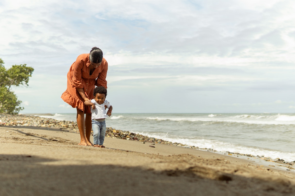A mother and her toddler son on the beach in La Ceiba, Honduras