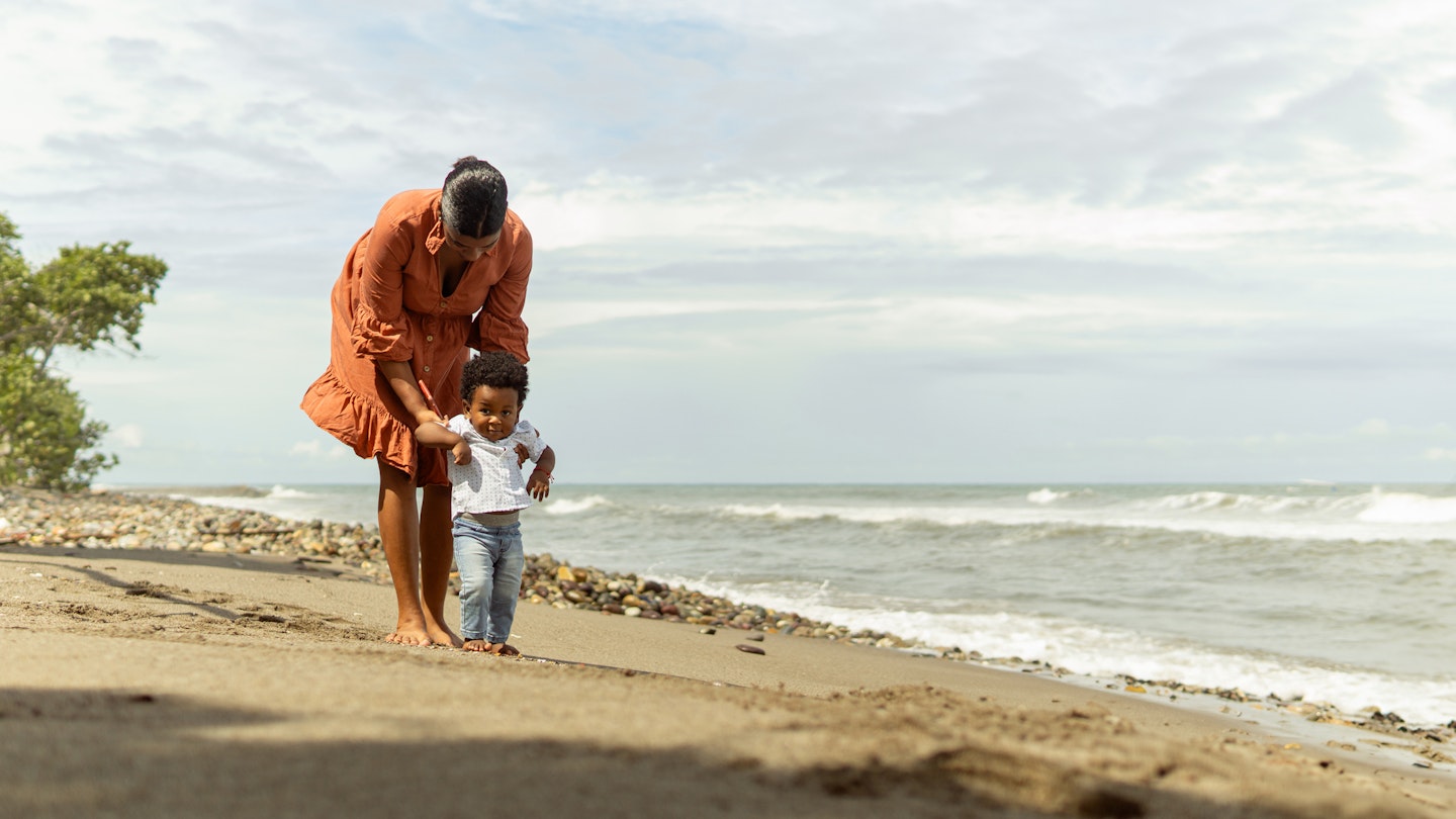A mother and her toddler son on the beach in La Ceiba, Honduras