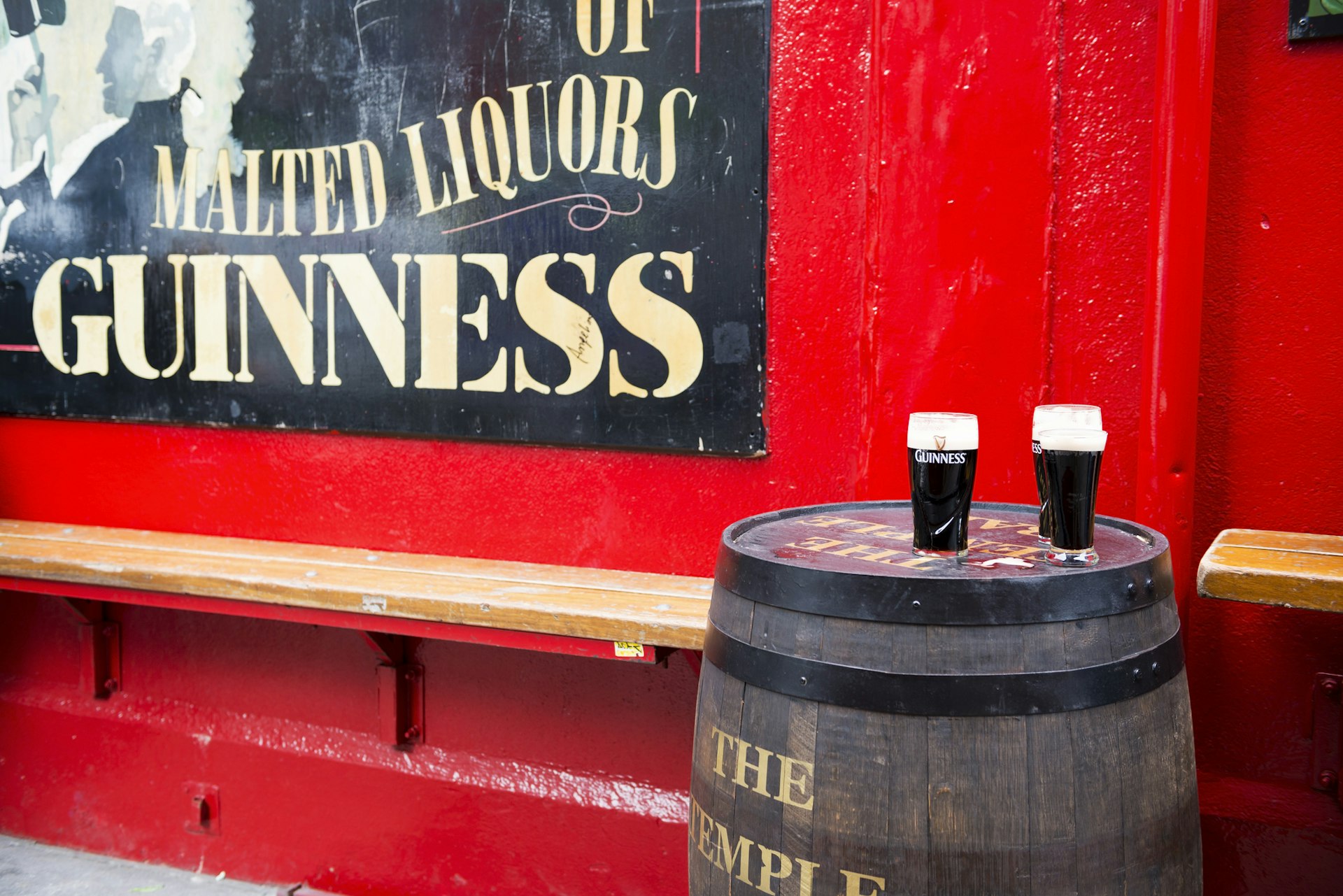 Pints of Guinness beer sit on a barrel outside Temple Bar